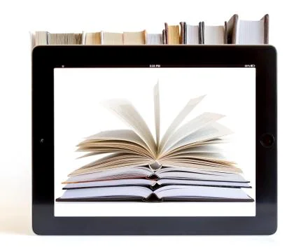 Tablet pc with books background Stock Photos