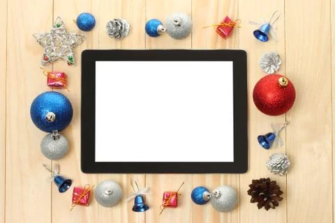 Tablet pc with christmas decorations. Stock Photos