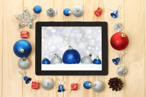 Tablet pc with christmas decorations. Stock Photos