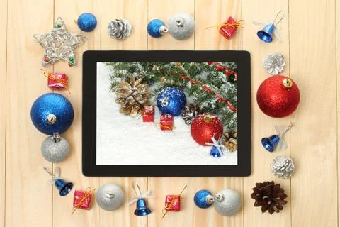 Tablet pc with christmas decorations. Stock Photos