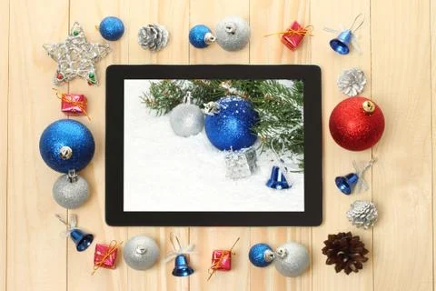 Tablet pc with christmas decorations. Stock Photos