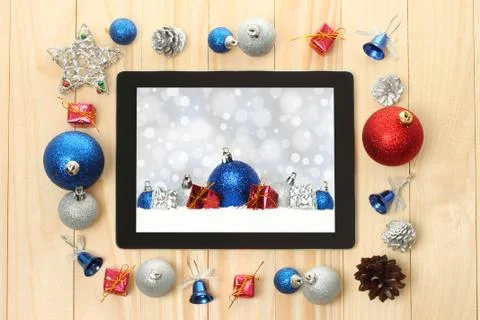 Tablet pc with christmas decorations. Stock Photos