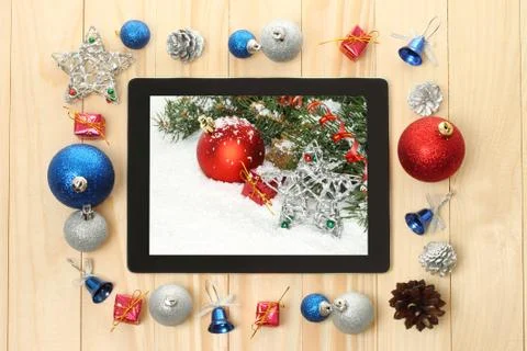 Tablet pc with christmas decorations. Stock Photos