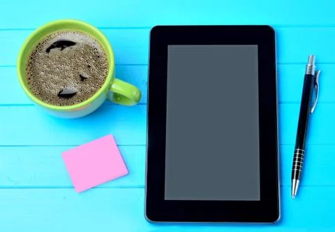 Tablet pc with coffee cup and notes on table Stock Photos
