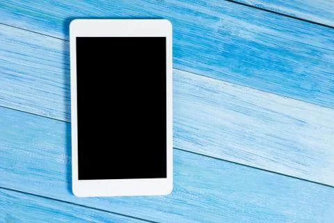 Tablet pc, empty blank screen on office table desk with set of colorful supplies Stock Photos