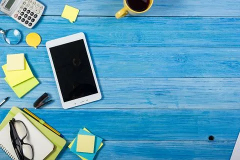 Tablet pc, empty blank screen on office table desk with set of colorful supplies Stock Photos