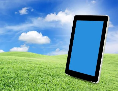 Tablet pc on green grass Stock Photos
