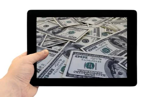 Tablet PC in hand with mount of hundred dollar banknotes background on screen Stock Photos
