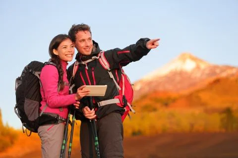 Tablet PC - hiking couple using travel app Stock Photos