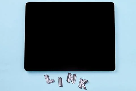 Tablet pc with link word on blue background. Stock Photos
