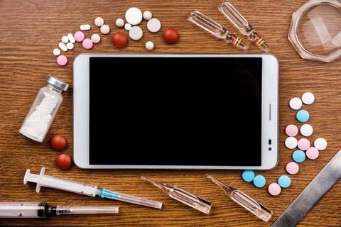 Tablet pc with medical objects on a desk as a metaphor for electronic diagn.. Stock Photos