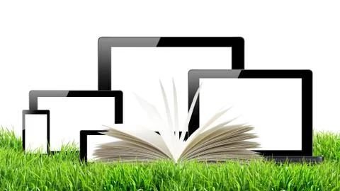 Tablet pc, mobile phone, computer and openned book in green grass Stock Photos