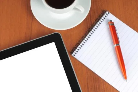 Tablet pc, notepad, pen and cup of coffee Stock Photos