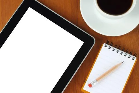 Tablet pc, notepad, pen, money and cup of coffee on wooden background Stock Photos