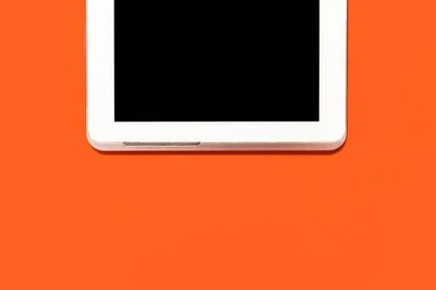 Tablet pc on an orange background Stock Photos