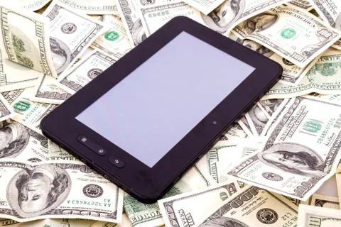 Tablet pc over dollars Stock Photos
