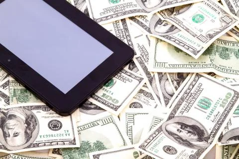 Tablet pc over dollars Stock Photos
