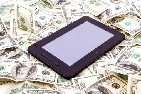 Tablet pc over dollars Stock Photos