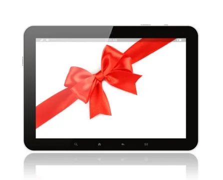 Tablet pc with red bow . Stock Photos