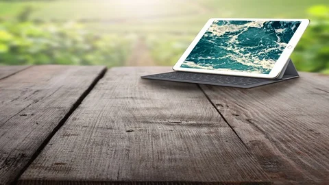 Tablet PC.  Tablet PC and keyboard on the wooden table outdoors. Stock Footage 88189967