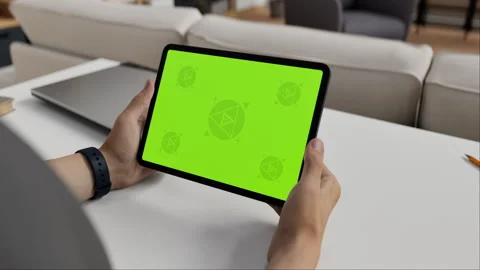 A tablet in a person's hand on an home office desk Stock Footage 292910589