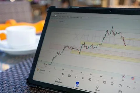 Tablet phone on the dining table. Trading foreign exchange anywhere Stock-Fotos