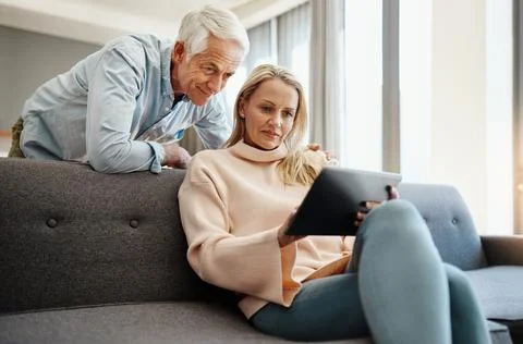 Tablet, plan and couch with couple and digital banking with budget and financial Fotos de archivo