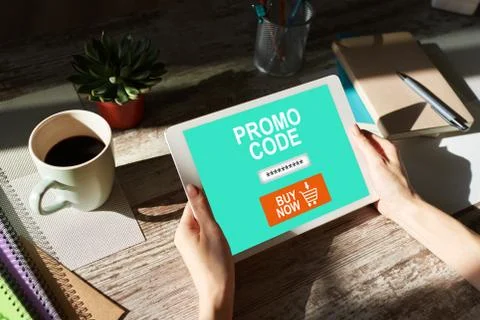 Tablet with promo code field on screen. E-commerce, mobile marketing concept. Fotos Stock