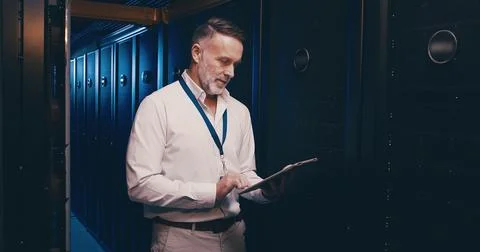 Tablet, reading and technician or man in server room for cyber security 写真素材
