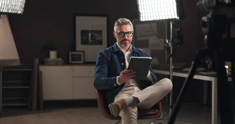 Tablet, recording and man on set reading script for documentary interview or Stockbeeldmateriaal 303540186