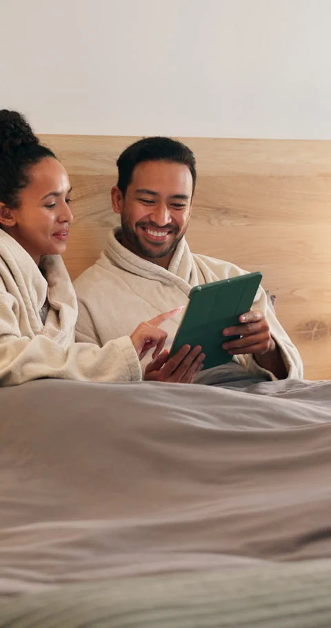 Tablet, relax and couple on bed in home with browsing social media, internet or Stock Footage 340817924