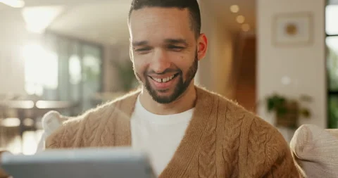 Tablet, relax and happy man on sofa, online search or news website with app at Stock Footage 335275839