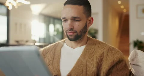 Tablet, relax and man on sofa, typing or online search for news website with app Stock Footage 335266251