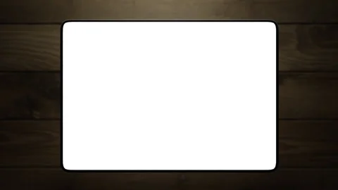 The tablet rises above the wooden table. the animation has a white screen Stock-Footage 260983174