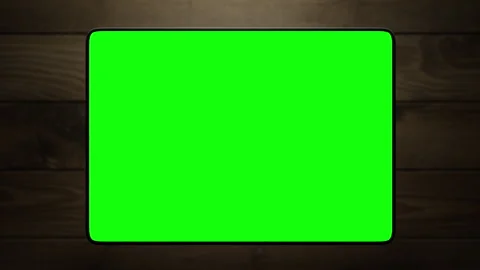 The tablet rises above the wooden table. The animation has a green screen Stock-Footage 260983243