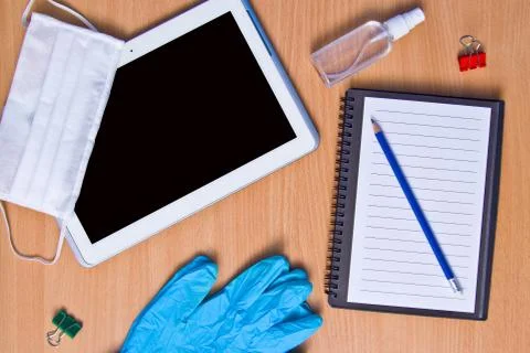 Tablet with rubber gloves test tubes and face mask top view. The concept of m Stock Photos