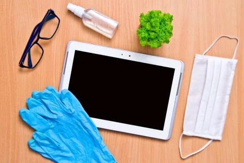 Tablet with rubber gloves test tubes and face mask top view. The concept of m Stock Photos