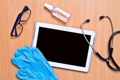 Tablet with rubber gloves test tubes and face mask top view. The concept of m Stock Photos