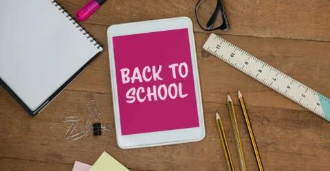 Tablet on a school table with back to school on screen Stock Photos