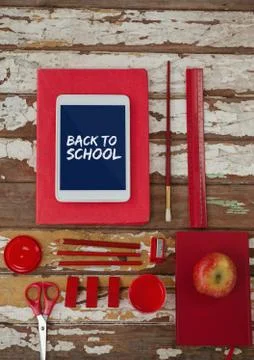 Tablet on a school table with back to school text on screen Stock Photos