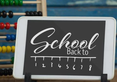 Tablet on a school table with back to school text on screen Stock Photos