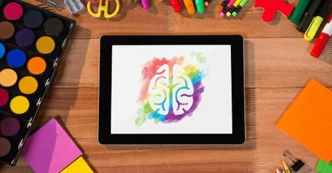 Tablet on a school table with colored brain on screen Stock Photos