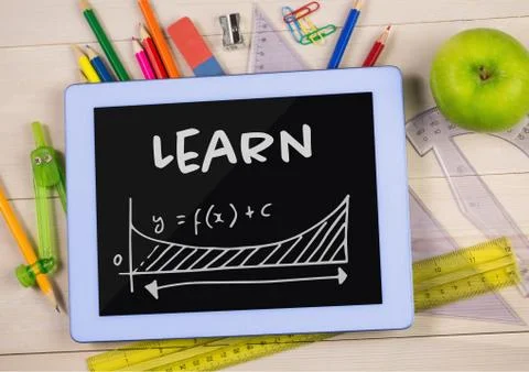 Tablet on a school table with school icons on screen Stock Photos