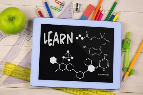 Tablet on a school table with school icons on screen Stock Photos