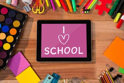 Tablet on a school table with school icons on screen Stock Photos