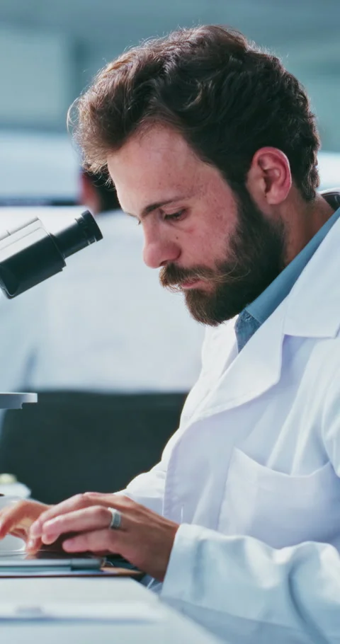 Tablet, science or man with microscope in lab, medical testing or experiment Stock Footage 331591040