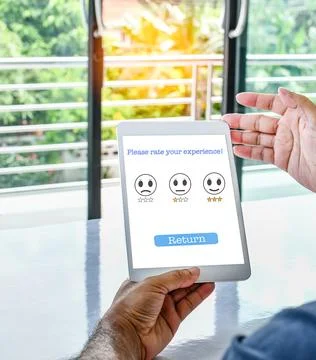 Tablet screen displays a Please rate your experience message to confirm Ser.. Stock Photos