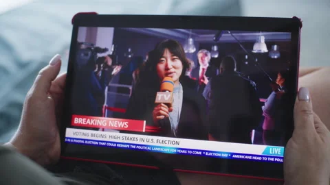 Tablet screen shows playback of news broadcast report about US election Stock Footage 279817002