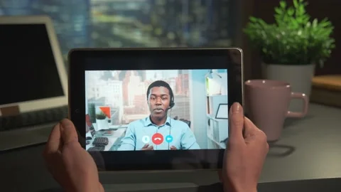 Tablet screen with video calling to mixed-race businessman Stock Footage 157596594