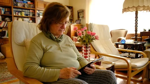 Tablet. Senior adult using digital technology device. Видео 144726258